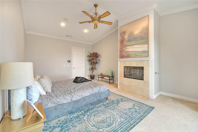 bedroom featuring lofted ceiling, light carpet, ornamental molding, a tile fireplace, and ceiling fan