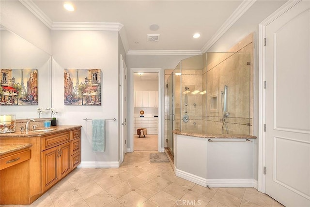 bathroom with a shower with door, crown molding, vanity, and tile patterned floors