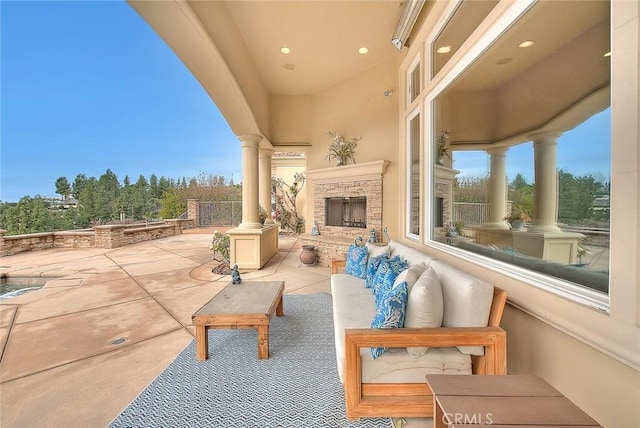 view of patio / terrace with an outdoor stone fireplace