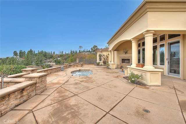 view of patio with an outdoor fireplace