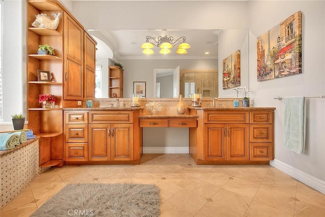 bathroom featuring a healthy amount of sunlight, ornamental molding, and vanity