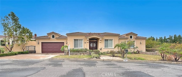 mediterranean / spanish-style home with a garage