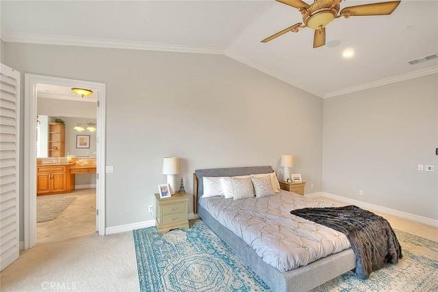 bedroom featuring lofted ceiling, connected bathroom, crown molding, light colored carpet, and ceiling fan