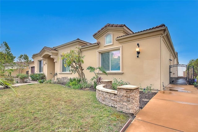 mediterranean / spanish house featuring a front lawn