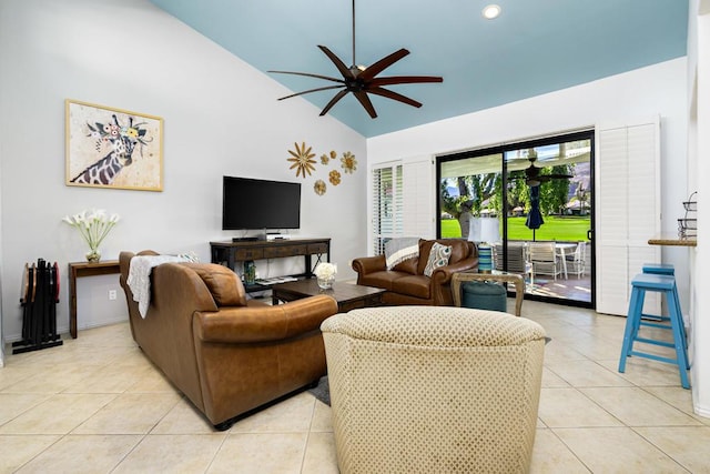 tiled living room featuring ceiling fan and vaulted ceiling