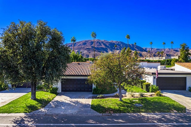 view of front of house with a garage and a mountain view