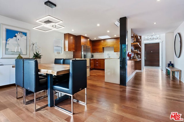 dining area featuring sink and light hardwood / wood-style flooring