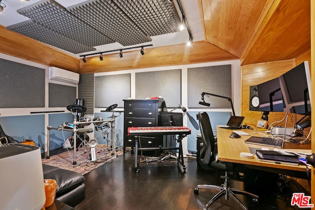 office area with hardwood / wood-style floors, an AC wall unit, and rail lighting