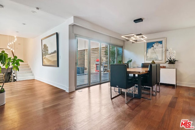 dining room featuring an inviting chandelier and hardwood / wood-style flooring