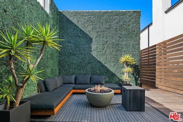 view of patio / terrace with an outdoor living space with a fire pit