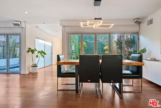 dining room with plenty of natural light and dark wood-type flooring