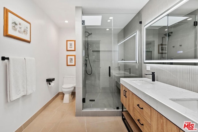 bathroom featuring vanity, an enclosed shower, tile patterned floors, and toilet