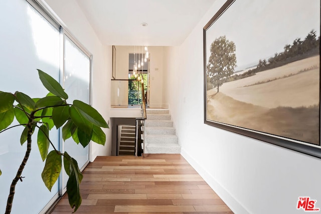 corridor with light hardwood / wood-style floors