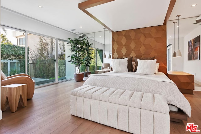 bedroom featuring access to exterior and light wood-type flooring