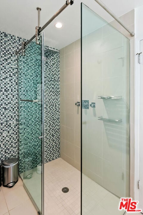 bathroom featuring an enclosed shower and tile patterned floors