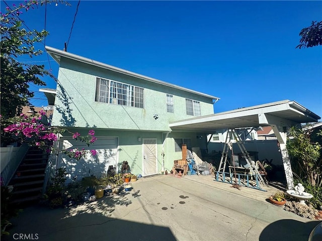 back of property with a garage