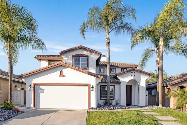 mediterranean / spanish-style house with a front yard and a garage