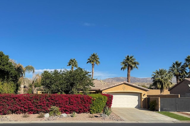 view of front of house with a garage and a mountain view