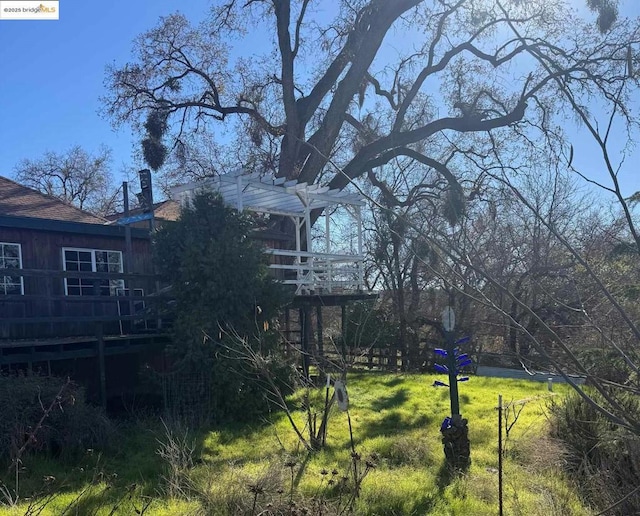 view of yard featuring a pergola and a deck