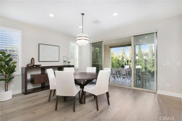 dining room with a chandelier and light hardwood / wood-style floors