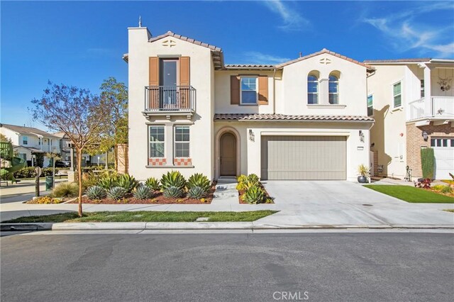 mediterranean / spanish-style house with a garage