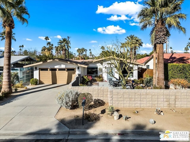 ranch-style house featuring a garage