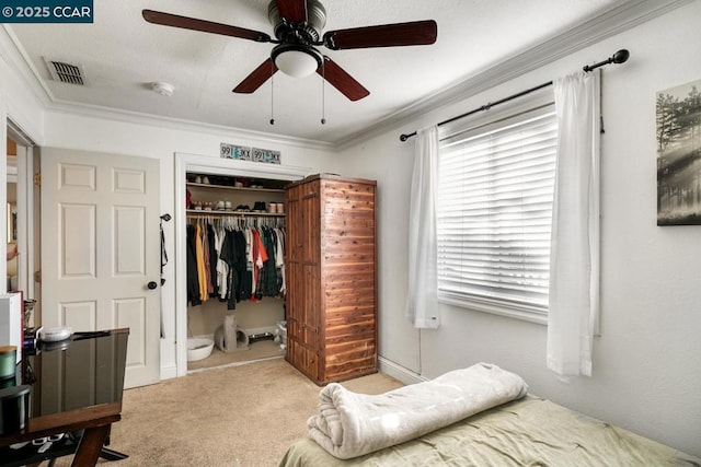 carpeted bedroom featuring a closet, ceiling fan, and ornamental molding