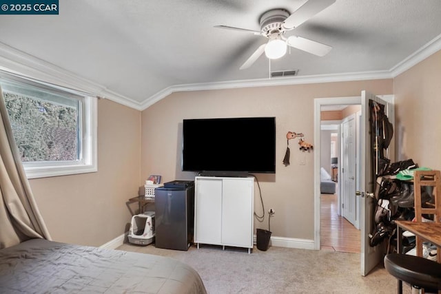 carpeted bedroom featuring ceiling fan, vaulted ceiling, and ornamental molding