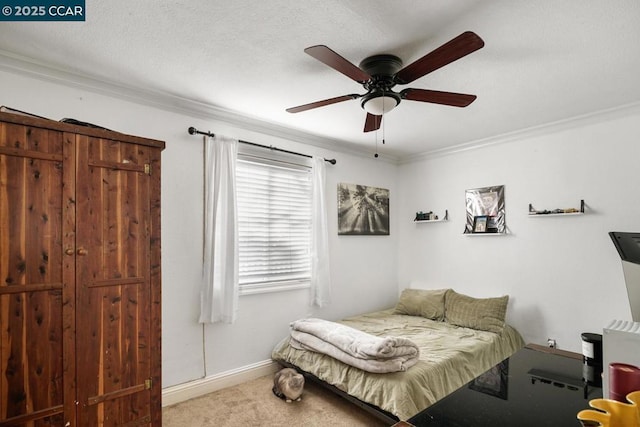 carpeted bedroom with ceiling fan and crown molding