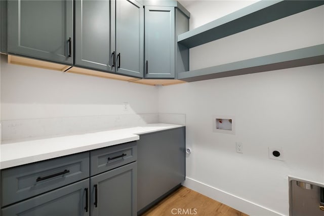 washroom featuring light wood-type flooring, cabinets, hookup for a washing machine, and hookup for an electric dryer