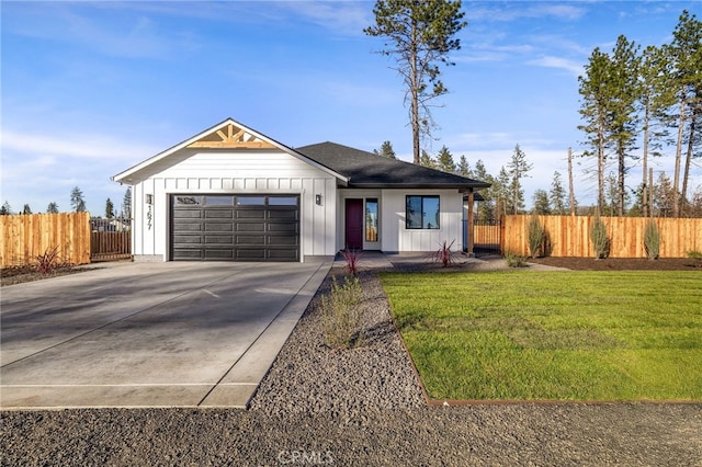 view of front of property with a garage and a front lawn