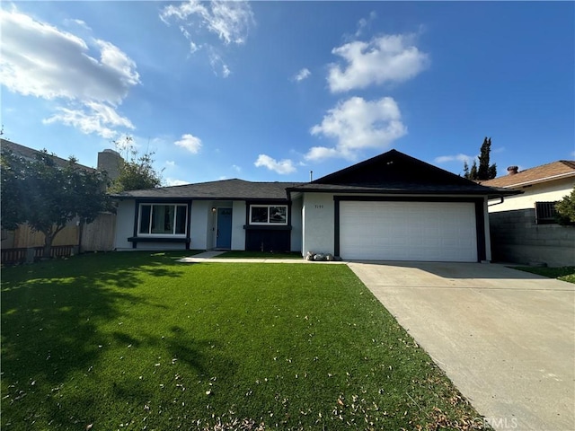 ranch-style home with a front yard and a garage