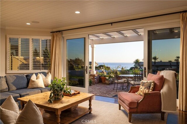 sunroom / solarium with wooden ceiling and a water view