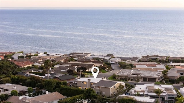 aerial view at dusk featuring a water view