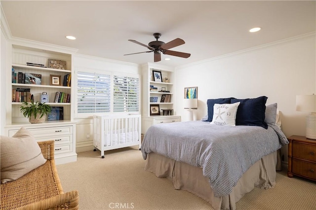 bedroom featuring ceiling fan, crown molding, and light carpet