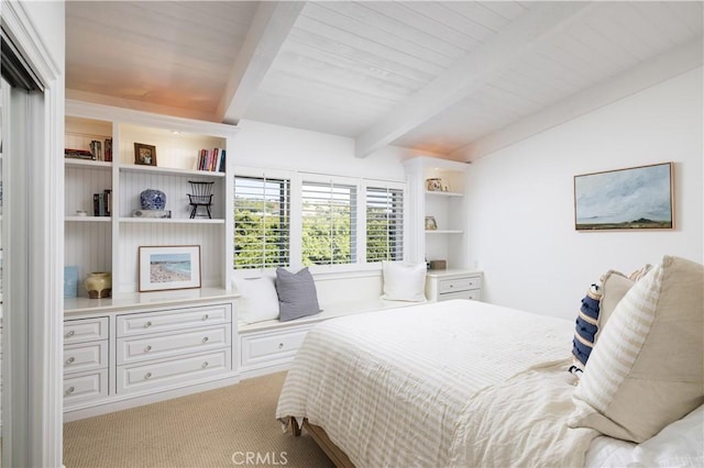 carpeted bedroom featuring beam ceiling