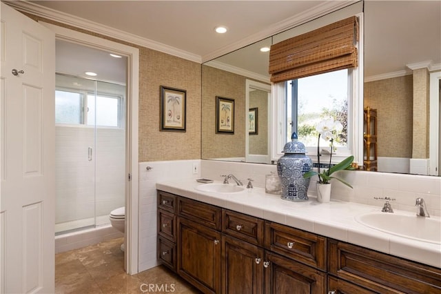 bathroom with toilet, vanity, tile patterned flooring, a shower with shower door, and ornamental molding