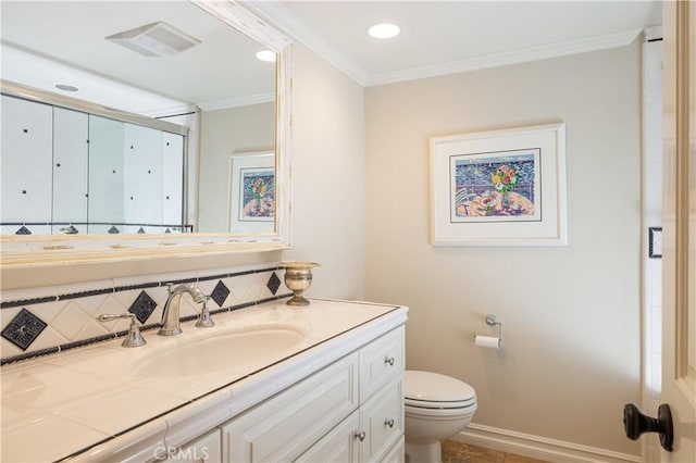 bathroom with decorative backsplash, toilet, vanity, and crown molding