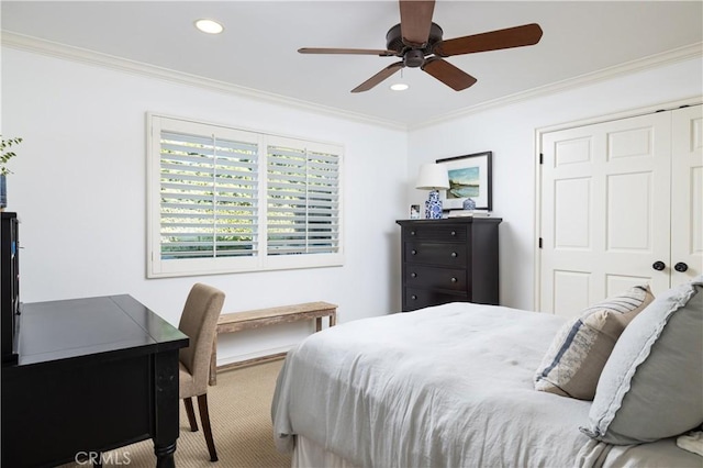 carpeted bedroom with ceiling fan, a closet, and ornamental molding