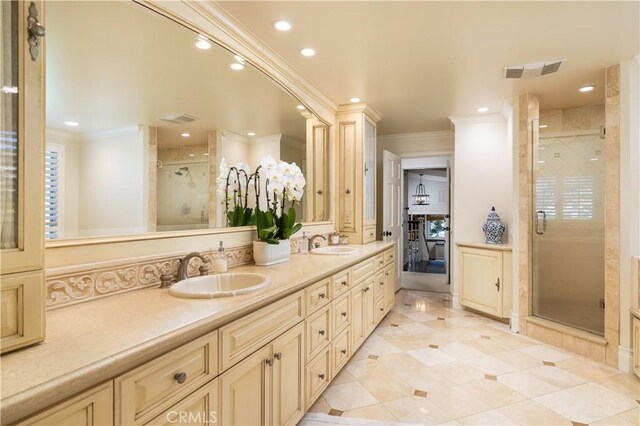 bathroom with a shower with door, ornamental molding, and vanity