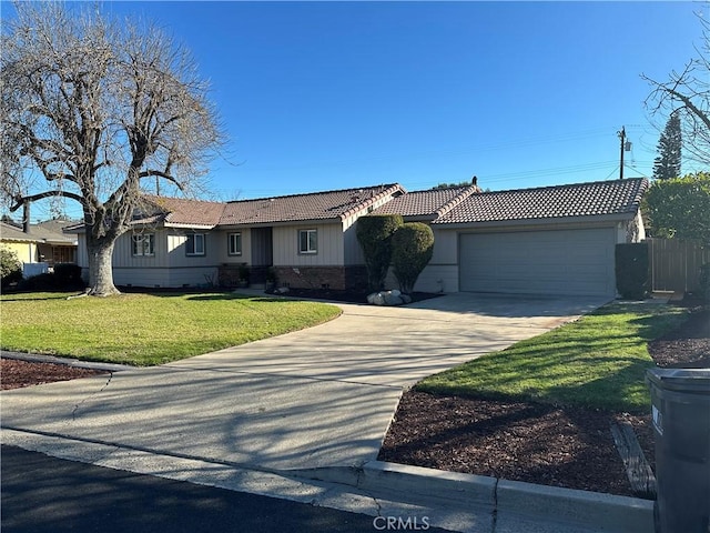 single story home featuring a front lawn and a garage