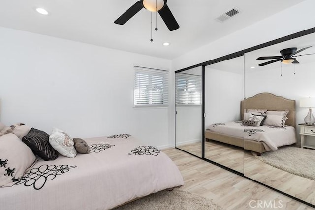 bedroom featuring ceiling fan, a closet, and light wood-type flooring