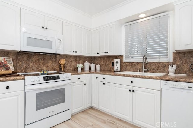 kitchen with white cabinetry, sink, white appliances, and tasteful backsplash