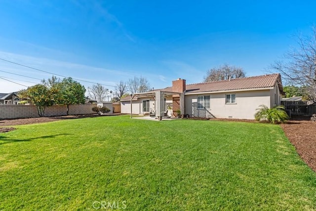 rear view of house featuring a patio area and a yard