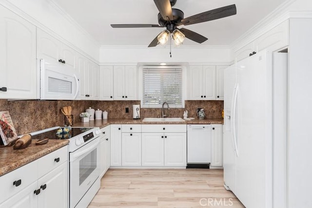 kitchen with white cabinetry, sink, white appliances, and decorative backsplash