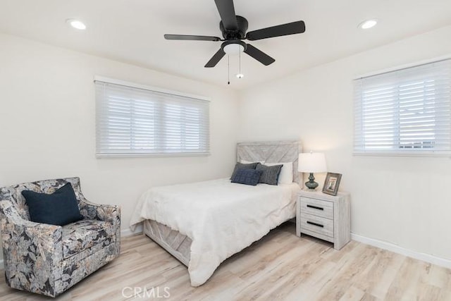 bedroom with ceiling fan and light hardwood / wood-style flooring