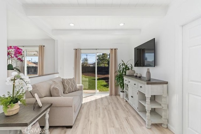 living room with beam ceiling and light wood-type flooring