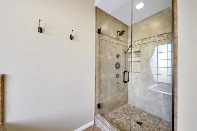 bathroom with a shower with door