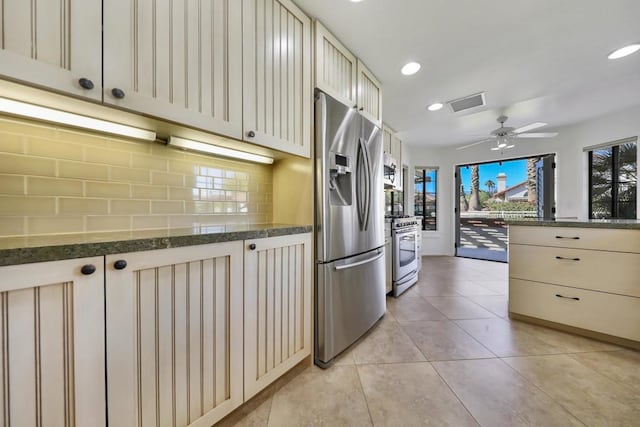 kitchen with cream cabinetry, ceiling fan, stainless steel appliances, tasteful backsplash, and light tile patterned flooring