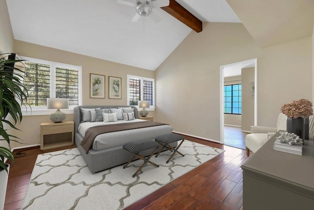 bedroom featuring ceiling fan, dark hardwood / wood-style floors, and vaulted ceiling with beams